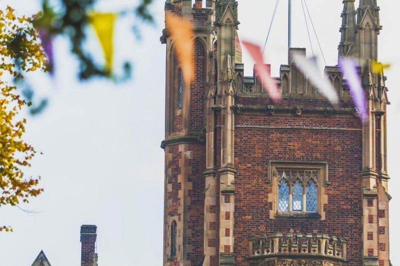 Part of teh red brick Lanyon rainbow with rainbow bunting in front of it